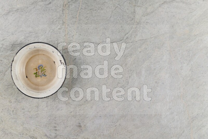 A vintage metal plate on grey marble background