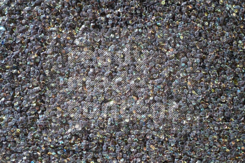 Multicolored flat sequins on grey background
