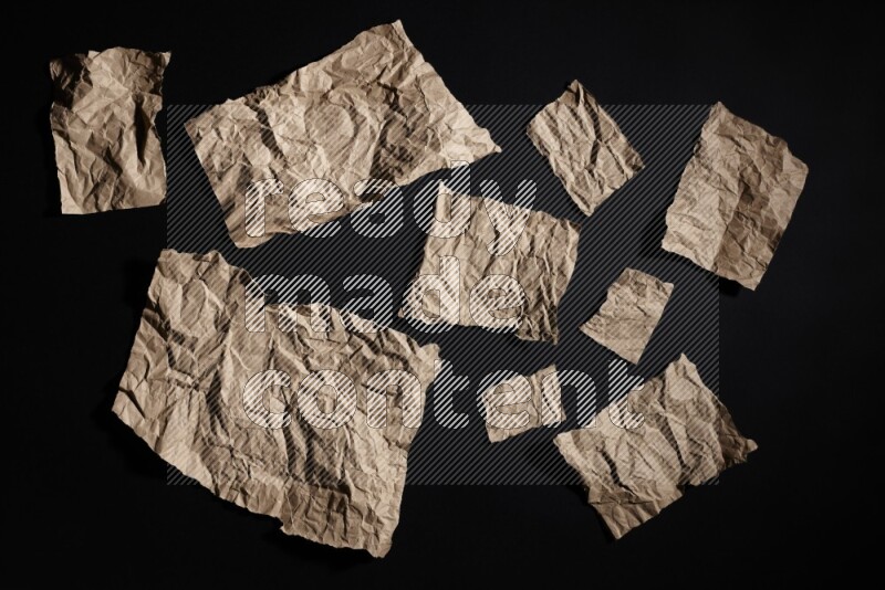 Crumpled craft paper on black background