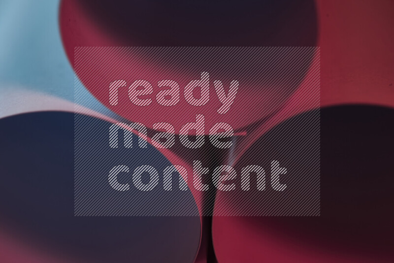 The image shows an abstract paper art with circular shapes in varying shades of blue and red