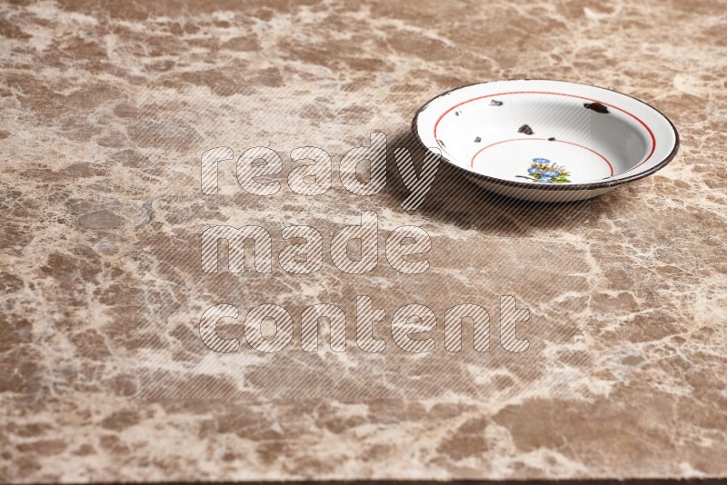 A vintage metal plate on beige marble background