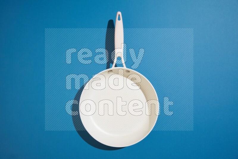 white pan on blue background