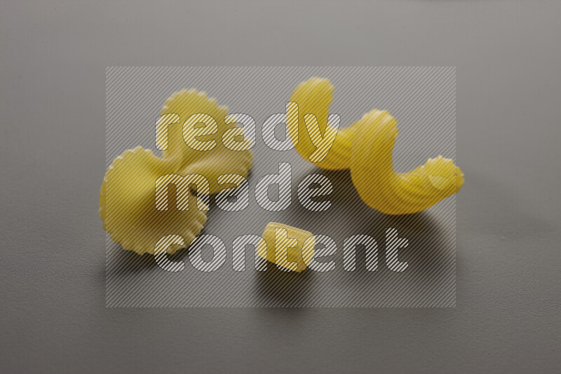 Different pasta types on grey background