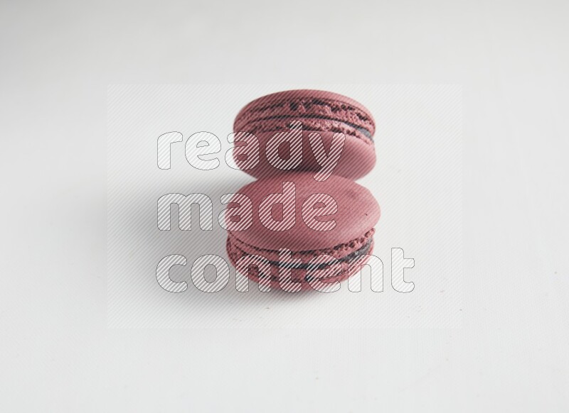 45º Shot of two Red Cherry macarons on white background