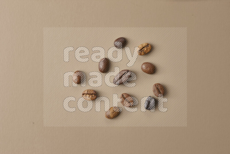 Roasted coffee beans on beige background