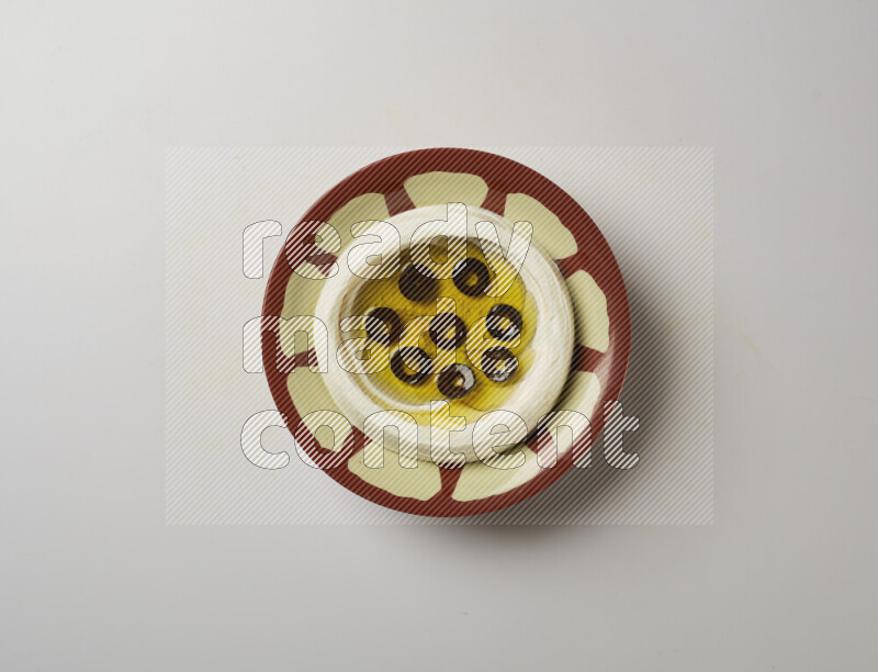 Lebnah garnished with sliced olives in a traditional plate on a white background