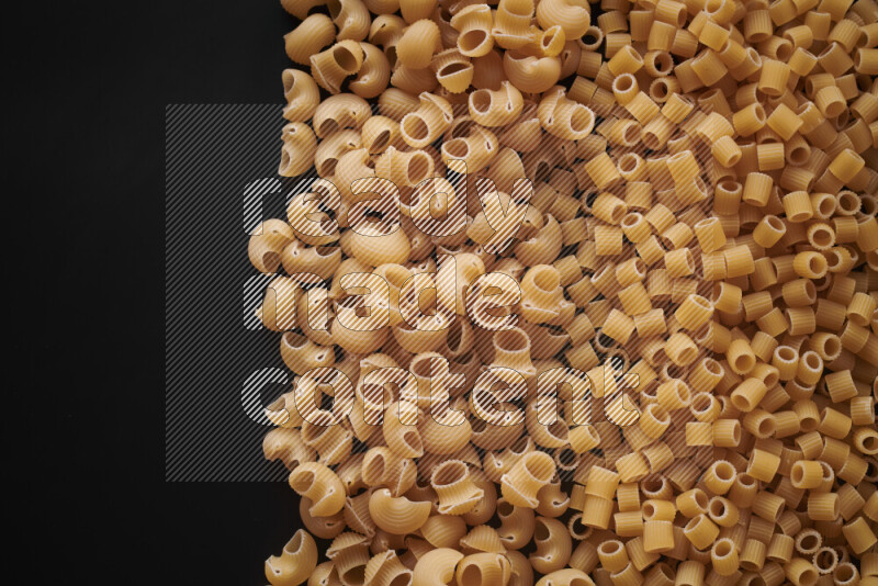 Different pasta types on black background