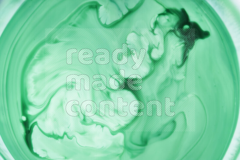 A close-up of abstract swirling patterns in green gradients