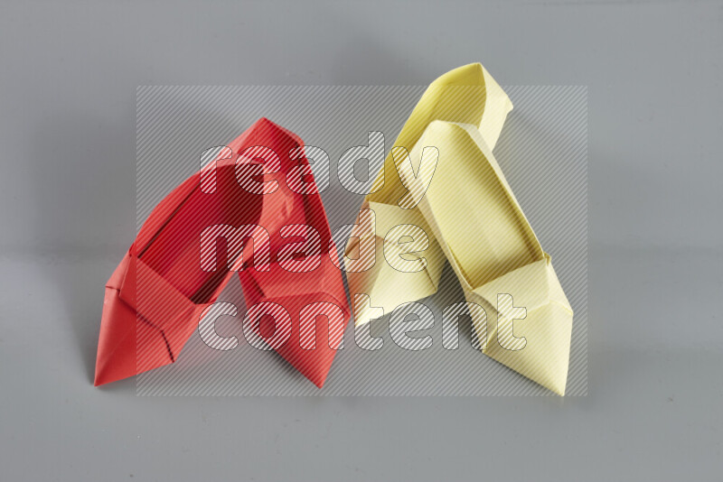 Origami shoes on grey background