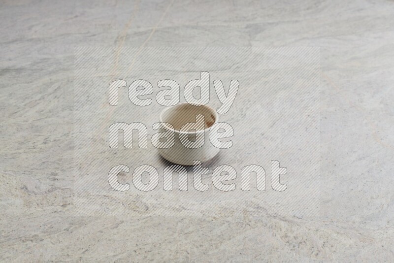 A white pottery bowl on grey marble background