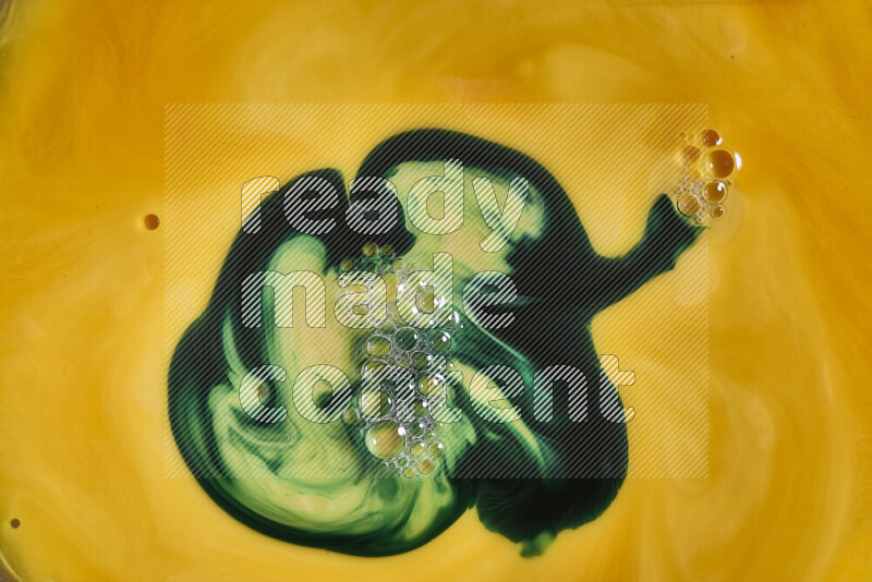 A close-up of abstract swirling patterns in orange and green