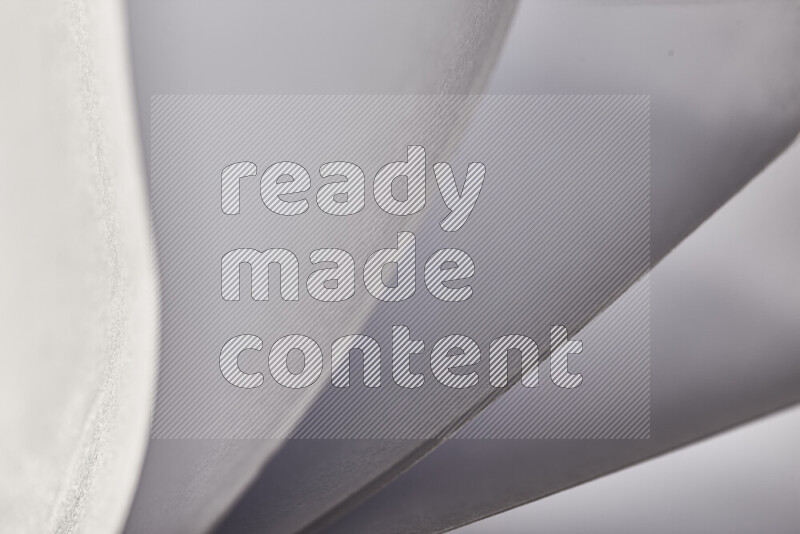 An abstract art showing grey paper sheets arranged in an overlapping curves