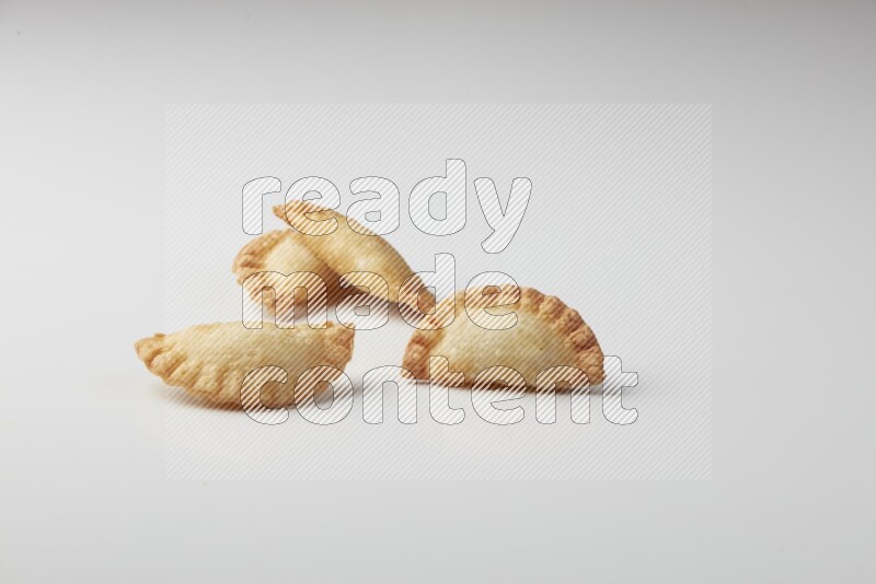 Four fried sambosas on a white background