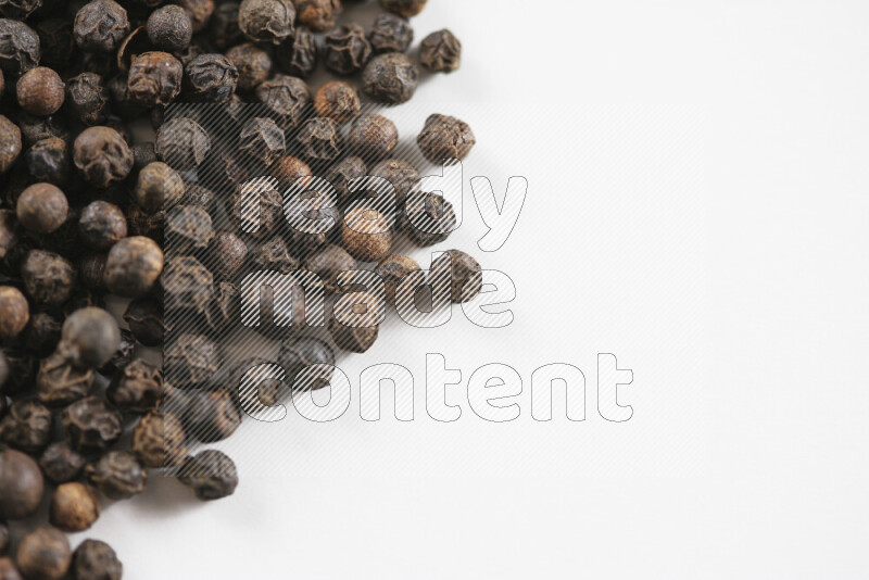 Black pepper beads on white background