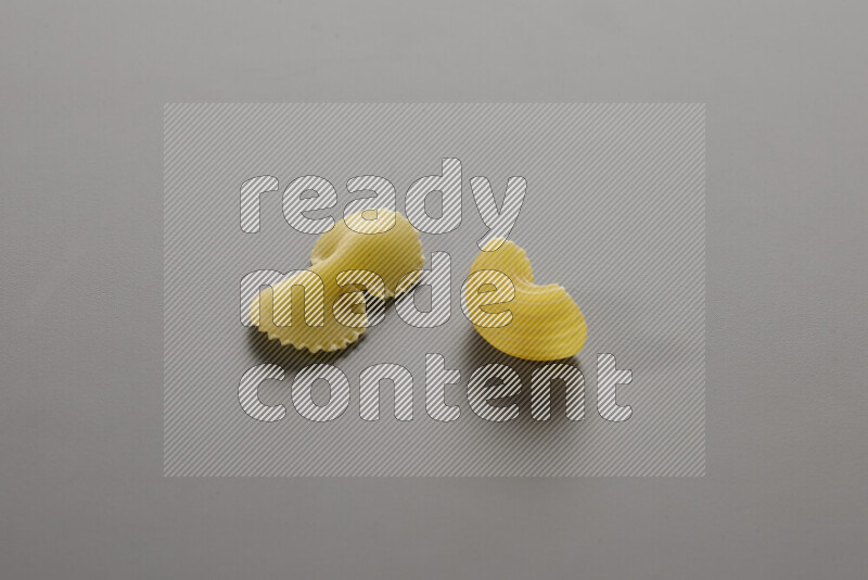 Fiocchi pasta with other types of pasta on grey background