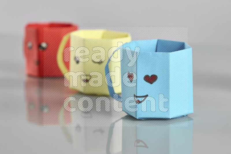 Origami cup on grey background