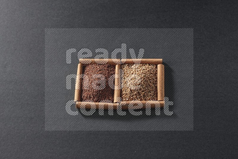 مربعان من أعواد القرفة ممتلئان بحبوب الخردل وحب الرشاد علي خلفية سوداء