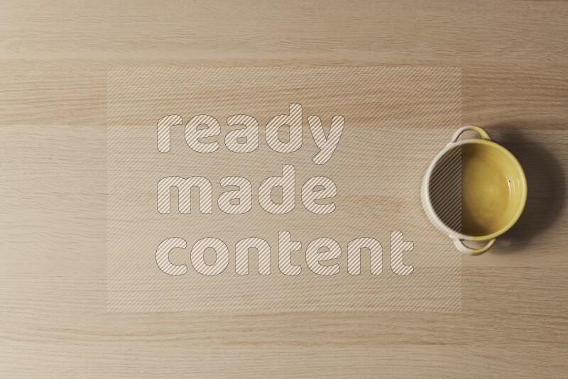 A multicolored pottery oven plate on light wooden background