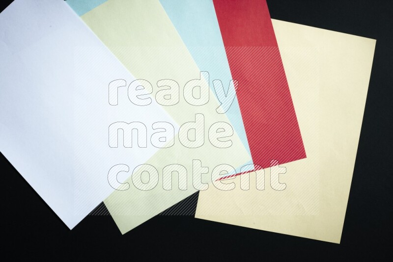 Multicolored paper sheet on black background