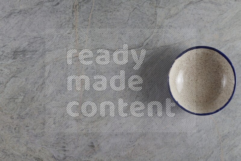 A multicolored pottery Bowl on grey marble background