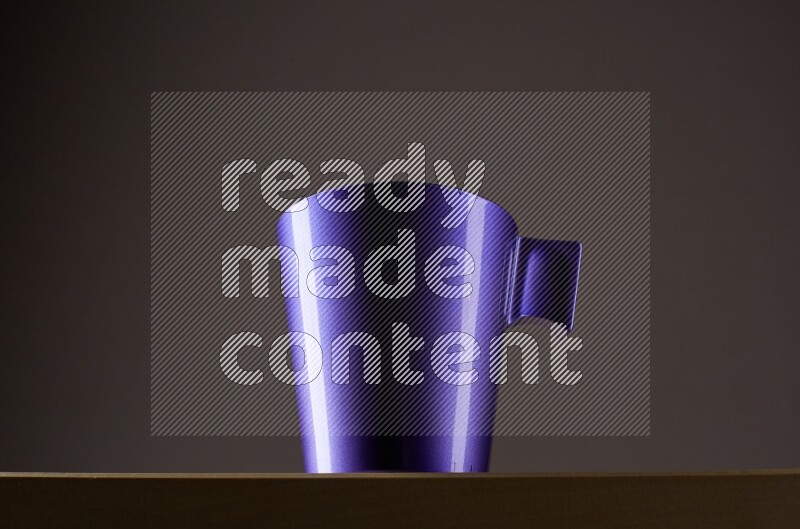 Low angle shot of a purple cup on grey background