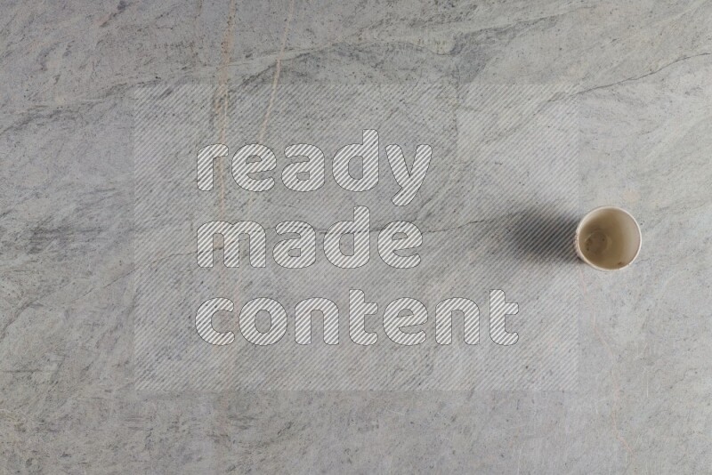 A multicolored pottery Cup on grey marble background