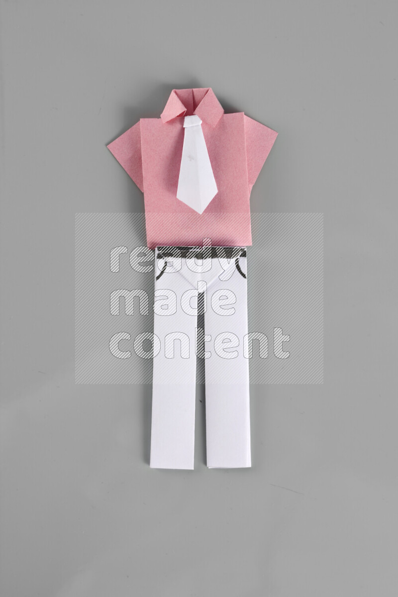 Origami clothes on grey background