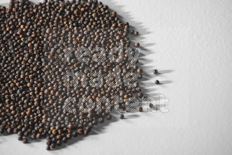 Black pepper on a white flooring