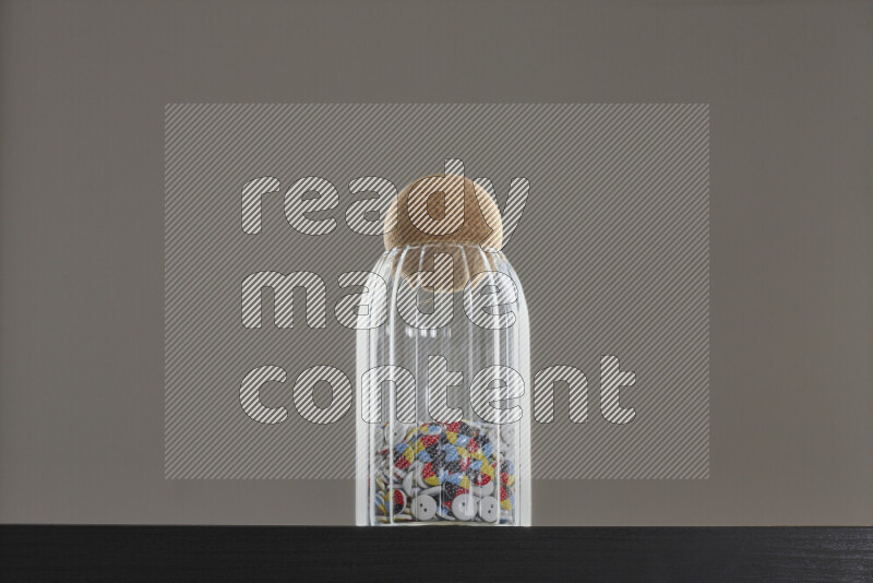 Buttons in a glass jar on black background