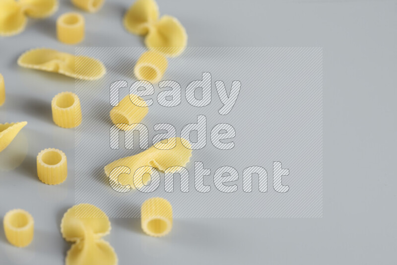 Different pasta types on light blue background
