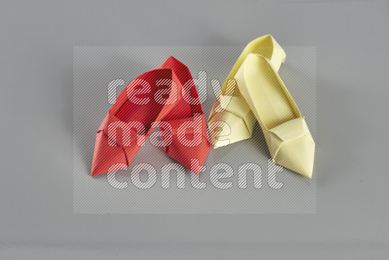 Origami shoes on grey background