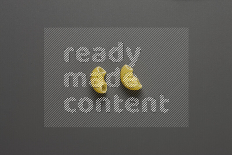 Elbow pasta on grey background
