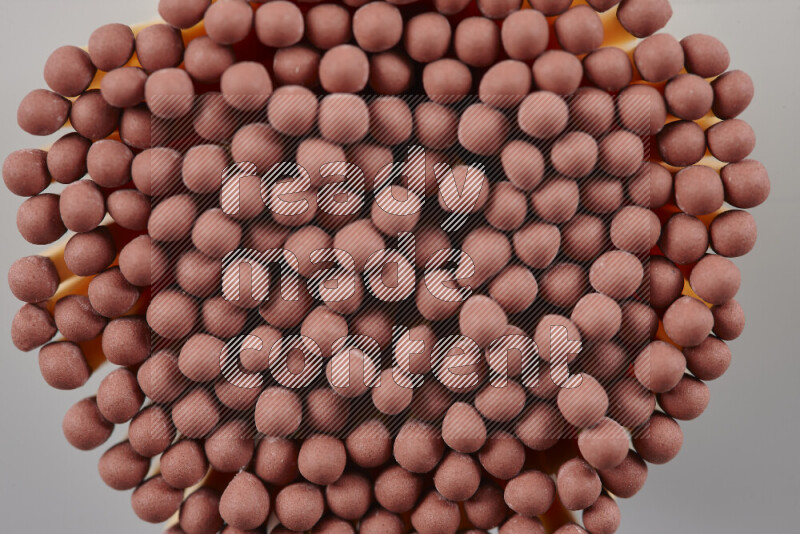 A close-up of a bundle of matches on grey background