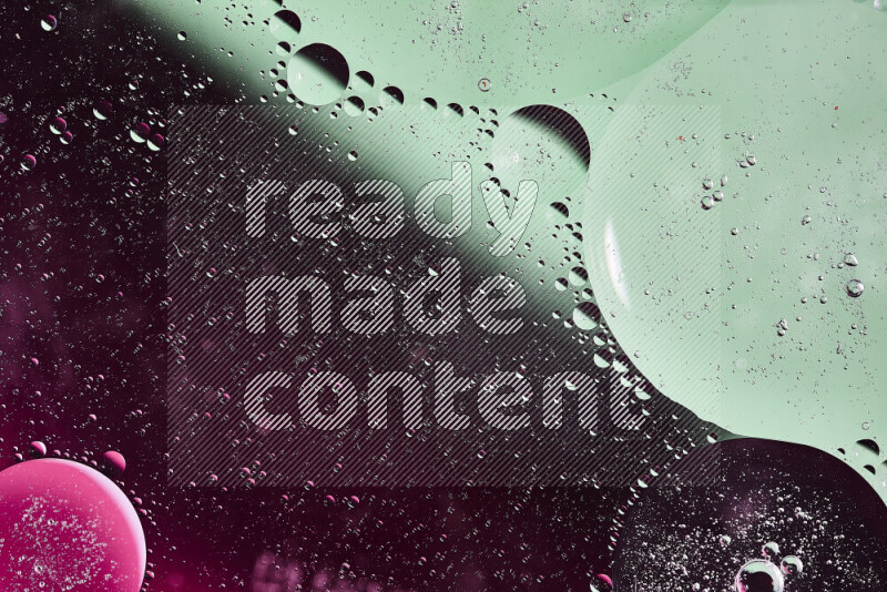 Close-ups of abstract oil bubbles on water surface in shades of green and pink