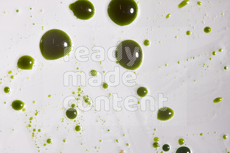 Close-ups of abstract green paint droplets on the surface