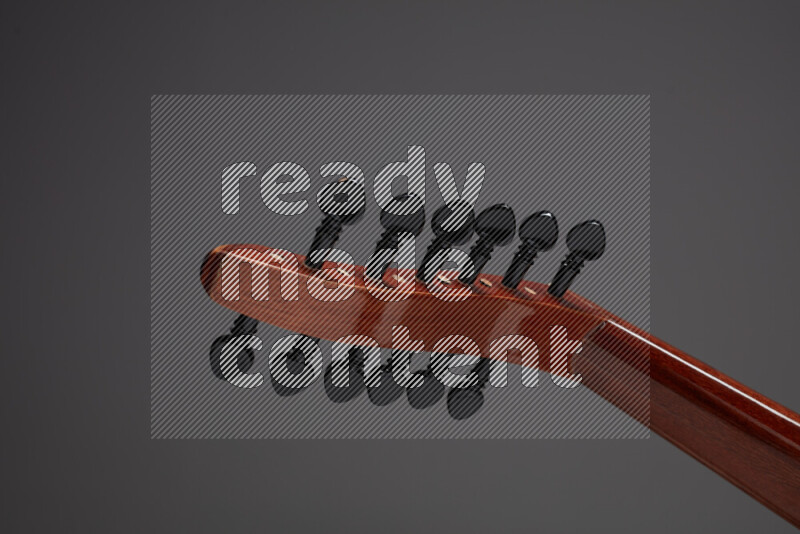 parts of a brown wooden Oud in a gray background
