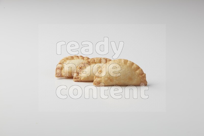 Three fried sambosas on a white background