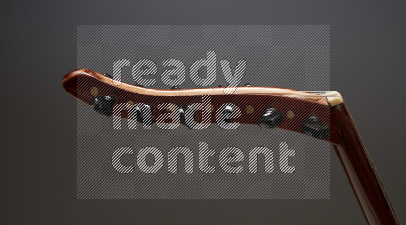 parts of a brown wooden Oud in a gray background