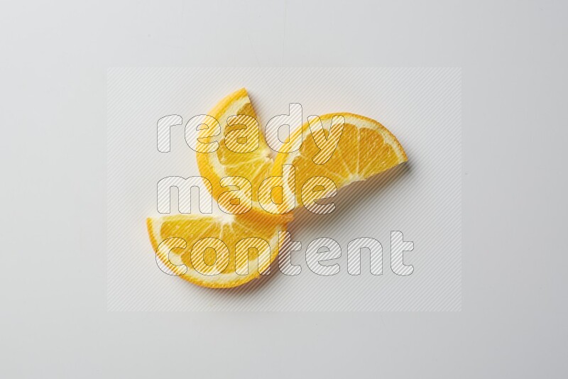 Three halves of an orange slices on white background