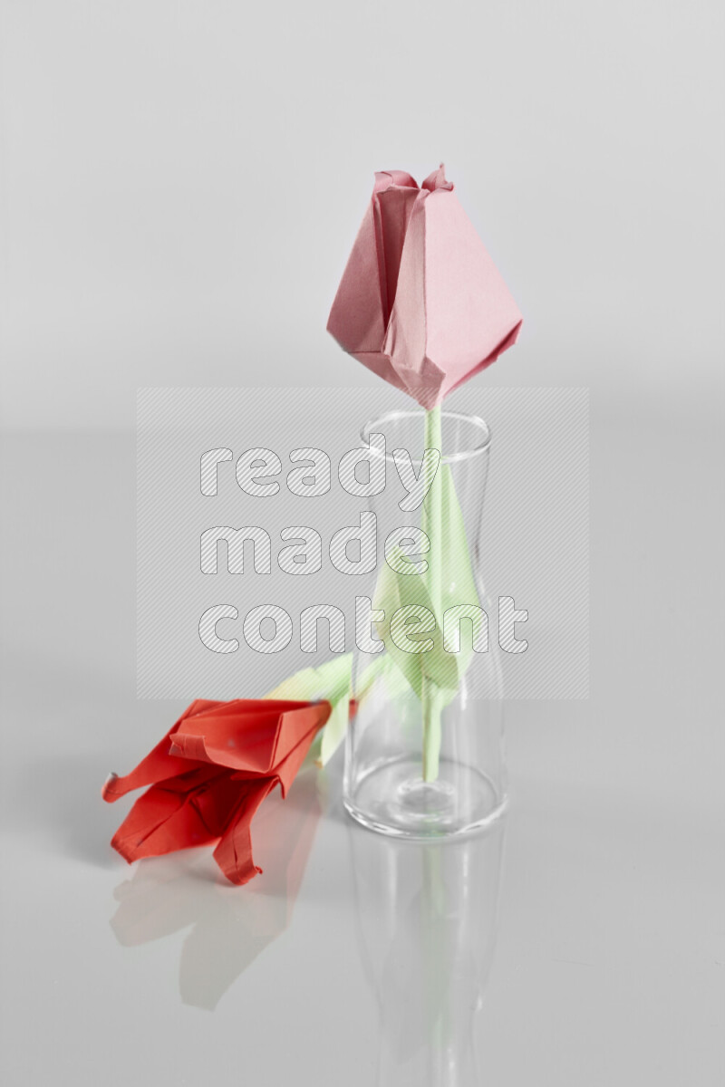 Origami flower on grey background