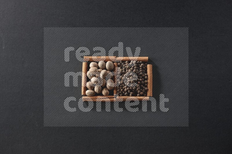 2 squares of cinnamon sticks full of nutmegs and allspice on black flooring