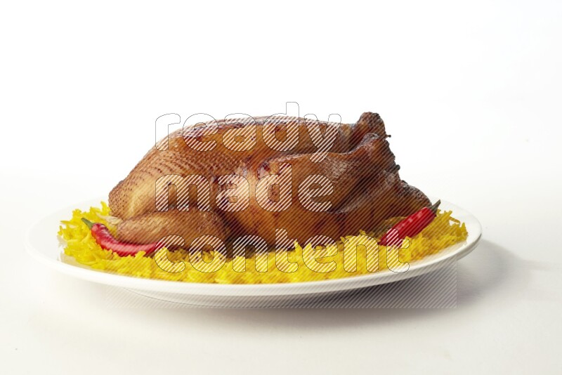 yellow  basmati Rice with  whole roasted chicken on a white rounded plate direct on white background