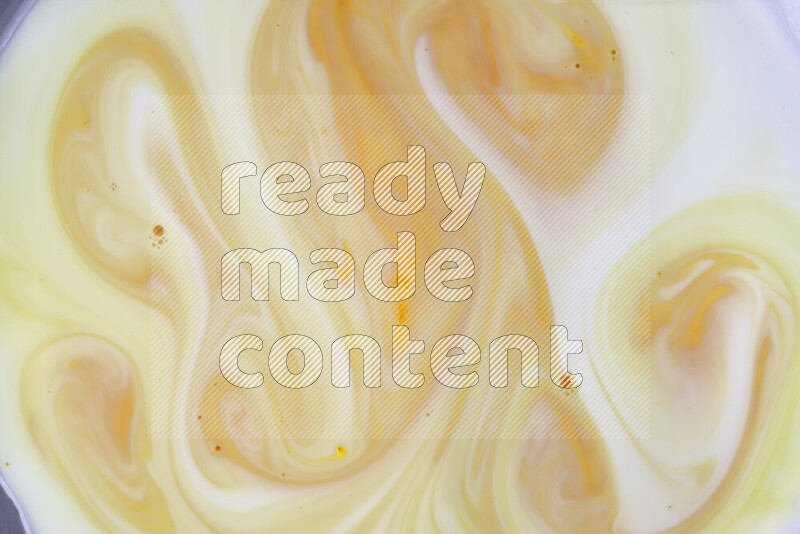 A close-up of abstract different swirling patterns in orange