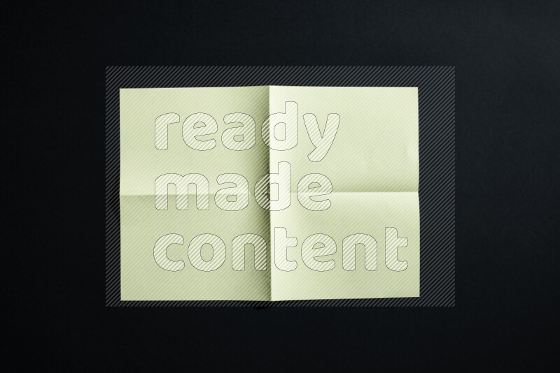 Yellow paper sheet on black background