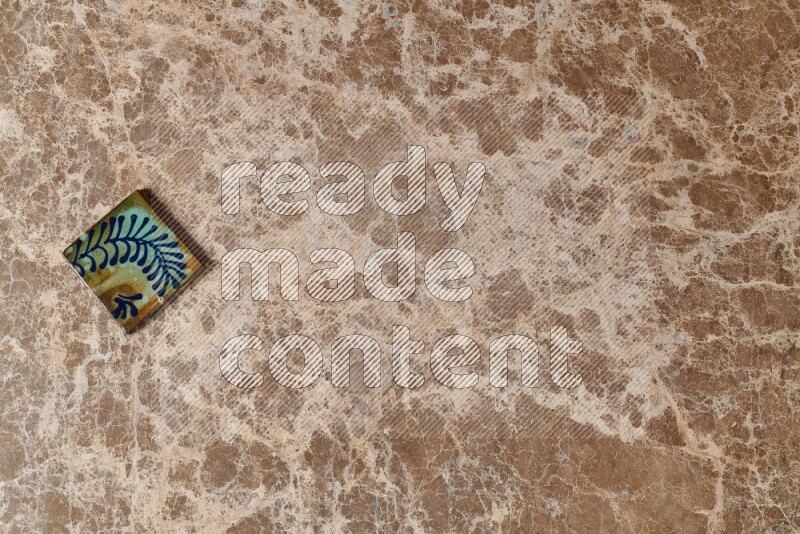 A decorative coaster on beige marble background