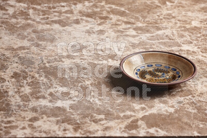 Decorative Pottery Plate on Beige Marble Flooring