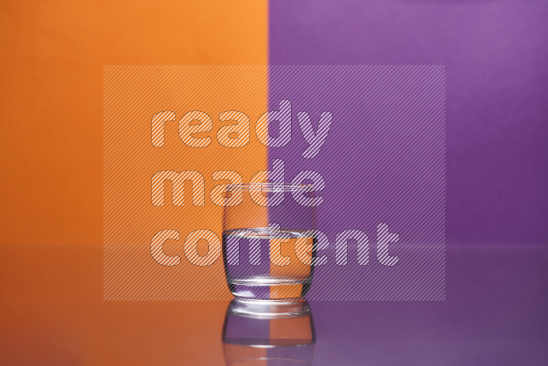 The image features a clear glassware filled with water, set against orange and purple background