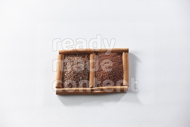 2 squares of cinnamon sticks full of flaxseeds and garden cress on white flooring