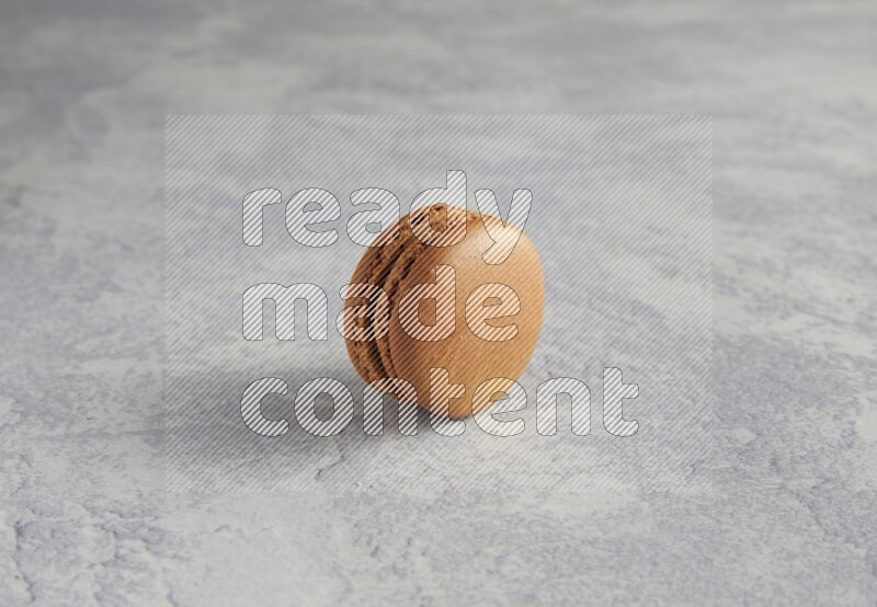 45º Shot of Brown Coffee macaron on white  marble background