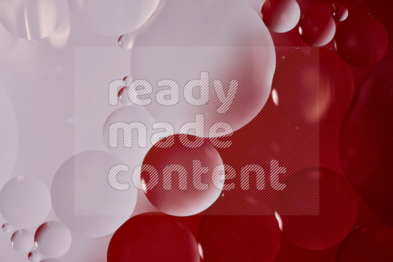 Close-ups of abstract oil bubbles on water surface in shades of white and red